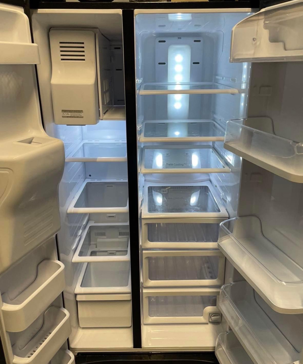 24.5 cu. ft. side by side refrigerator with a black finish, featuring twin cooling plus system