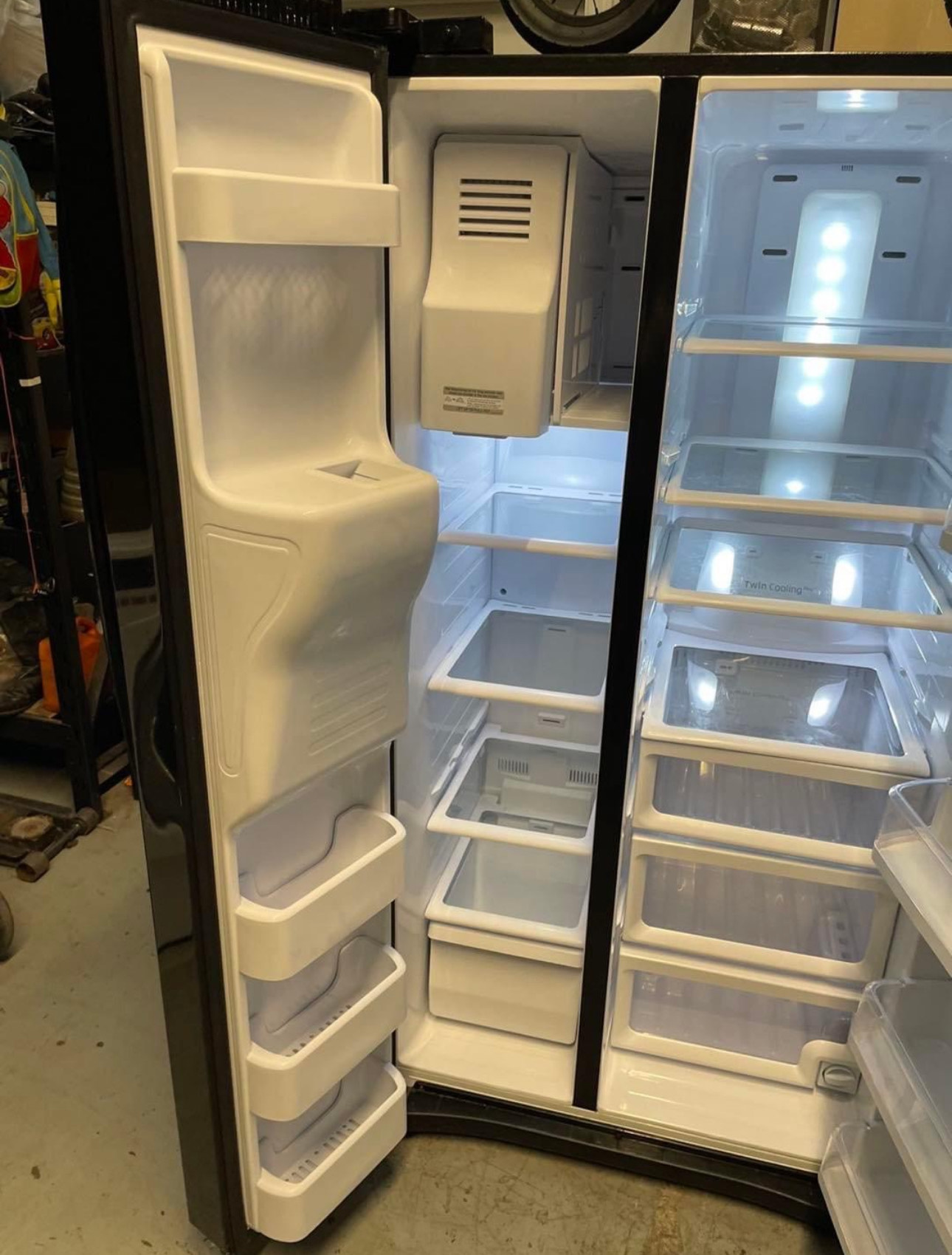 24.5 cu. ft. side by side refrigerator with a black finish, featuring twin cooling plus system