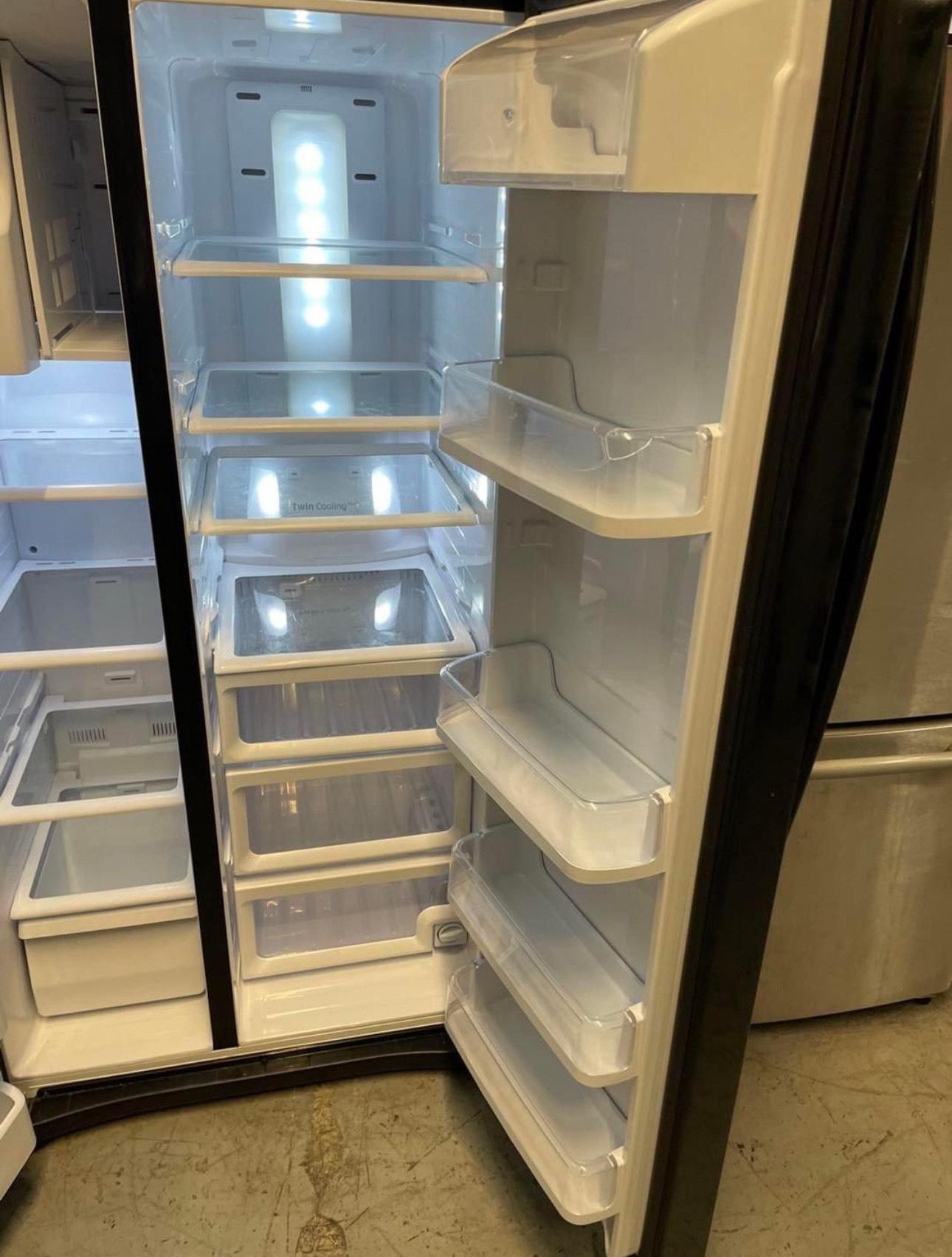 24.5 cu. ft. side by side refrigerator with a black finish, featuring twin cooling plus system